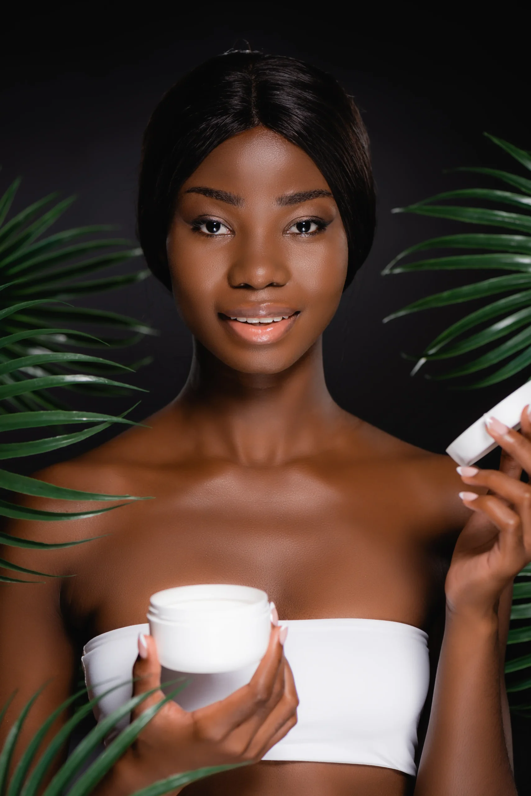 african-american-woman-with-cosmetic-cream-near-gr
